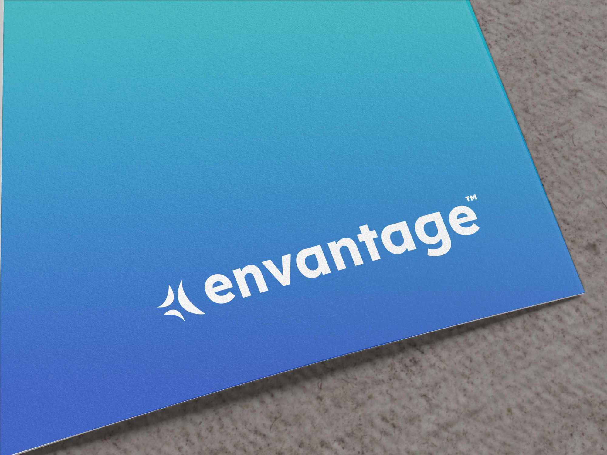 The Envantage logo in white on a teal to blue gradient, printed on textured paper